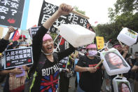 People gather with images of Taiwanese President Tsai Ing-wen for a protest in Taipei, Taiwan, Sunday, Nov. 22. 2020. Thousands of people marched in streets on Sunday demanding the reversal of a decision to allow U.S. pork imports into Taiwan, alleging food safety issues. (AP Photo/Chiang Ying-ying)