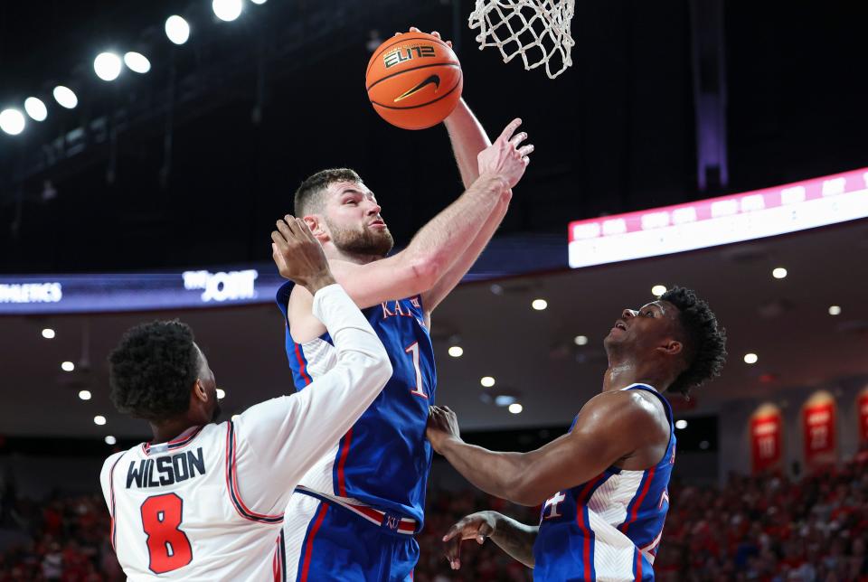 Kansas basketball center Hunter Dickinson (1) looks to score as Houston guard Mylik Wilson (8) defends during the first half of a March 9, 2024 game in Houston, Texas.