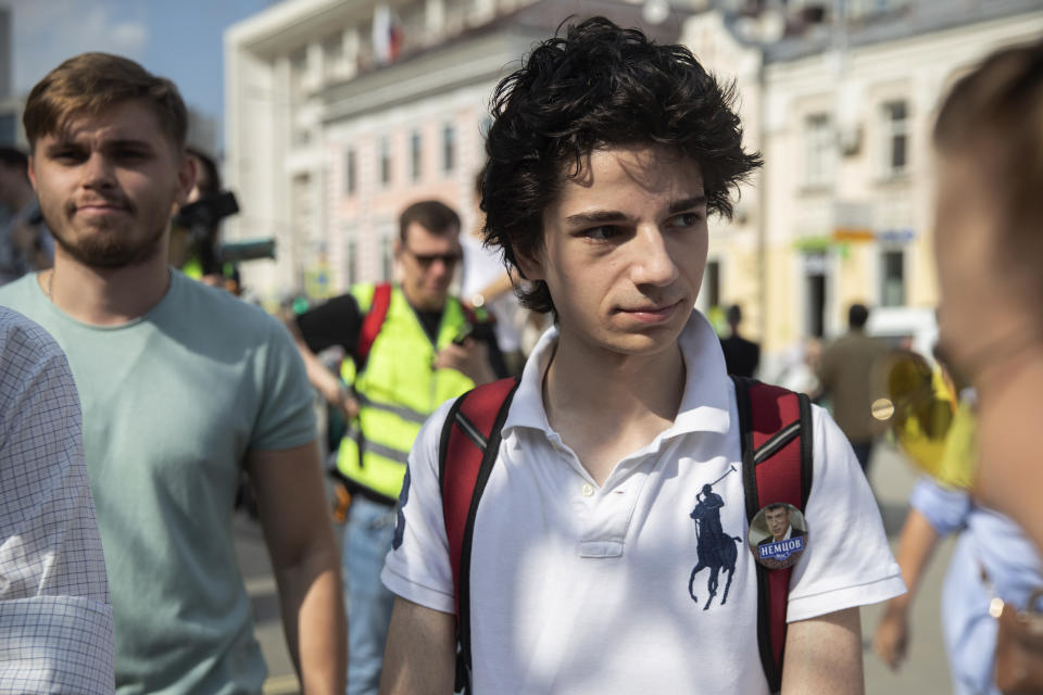 In this photo taken on Saturday, Aug. 31, 2019, Emile Yunusov, right, and Danil Denisov, left, members of the small, grassroots group Bessrochka take part in protest march in Moscow. "A new generation has appeared that sees what is happening (in Russia) and has much less to lose," says Yunusov, adding that the older generation is more constricted by family worries and work issues. (AP Photo/Pavel Golovkin)