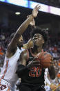 Georgia forward Rayshaun Hammonds (20) shoots defended by Auburn forward Anfernee McLemore (24) during the first half of an NCAA college basketball game Saturday, Jan. 11 2020, in Auburn, Ala. (AP Photo/Julie Bennett)