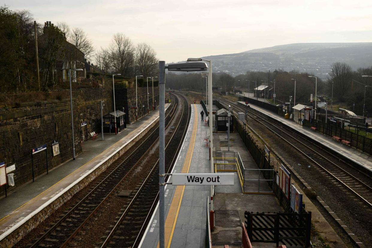 A single passenger waits on the station platform at rush hour in the village of Marsden, near Huddersfield, amidst the novel coronavirus Covid-19 pandemic: AFP via Getty Images