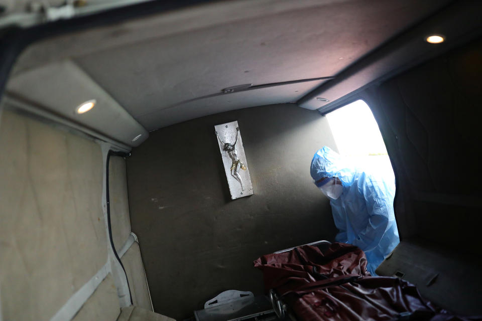 An employee wearing protective clothing disinfects a stretcher at Funeral Gayosso, as the outbreak of the coronavirus disease (COVID-19) continues in Mexico City, Mexico May 11, 2020. Picture taken May 11, 2020. REUTERS/Edgard Garrido