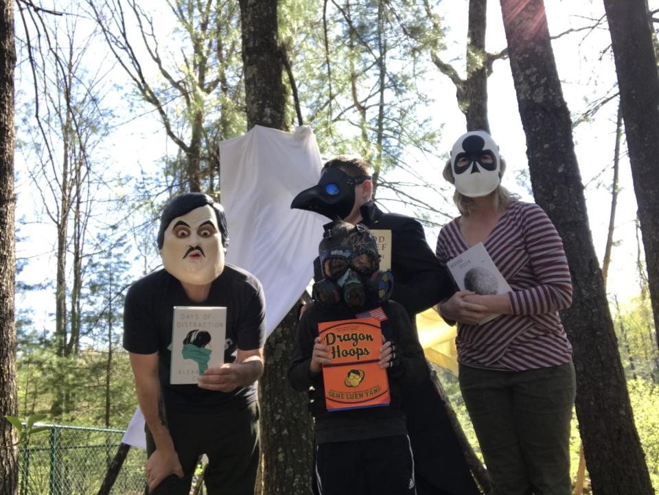 Clowning with books in the woods: Author Kevin Wilson (left) with his sons Patch and Griff (behind) and wife Leigh Anne Couch.