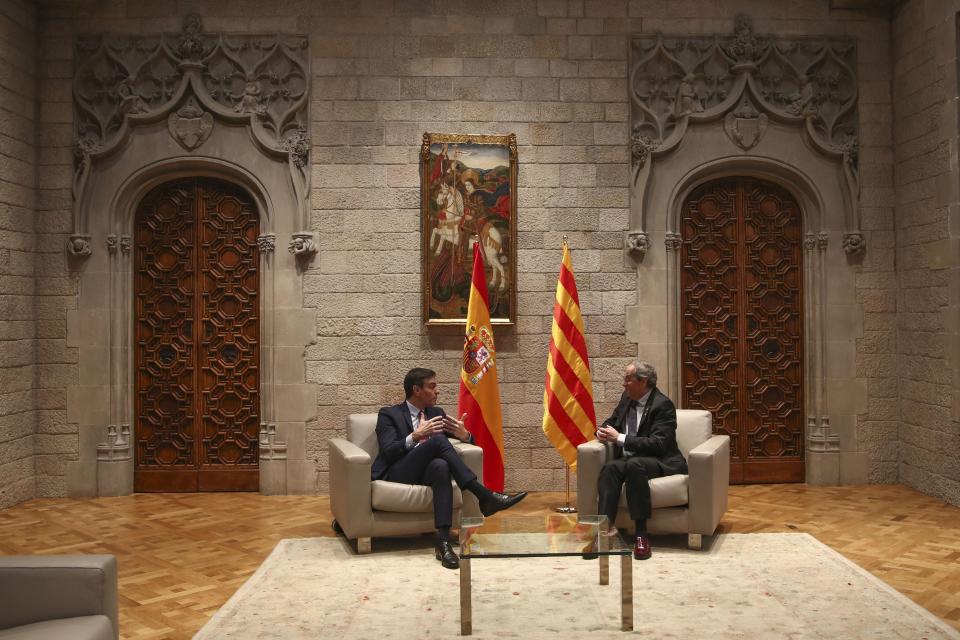 Spanish Prime Minister Pedro Sanchez, left, talks with Catalan regional President Quim Torra at the Palace of the Generalitat, the headquarter of the Government of Catalonia, in Barcelona, Thursday, Feb. 6, 2020. (AP Photo/Emilio Morenatti)