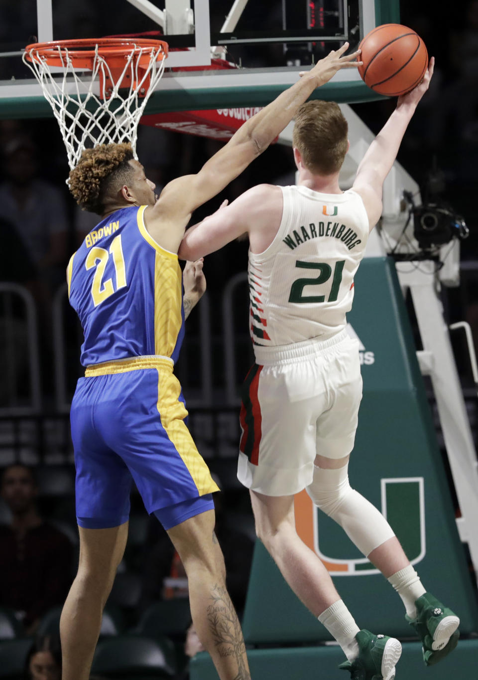 Miami forward Sam Waardenburg, right, is fouled by Pittsburgh forward Terrell Brown, left, during the first half of an NCAA college basketball game, Sunday, Jan. 12, 2020, in Coral Gables, Fla. (AP Photo/Lynne Sladky)