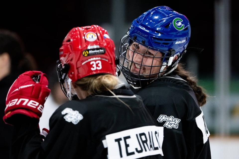 Tejralová speaks with fellow defender Victoria Howran at TD Place on Friday.