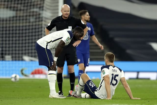 Eric Dier, right, awaits treatment against Chelsea