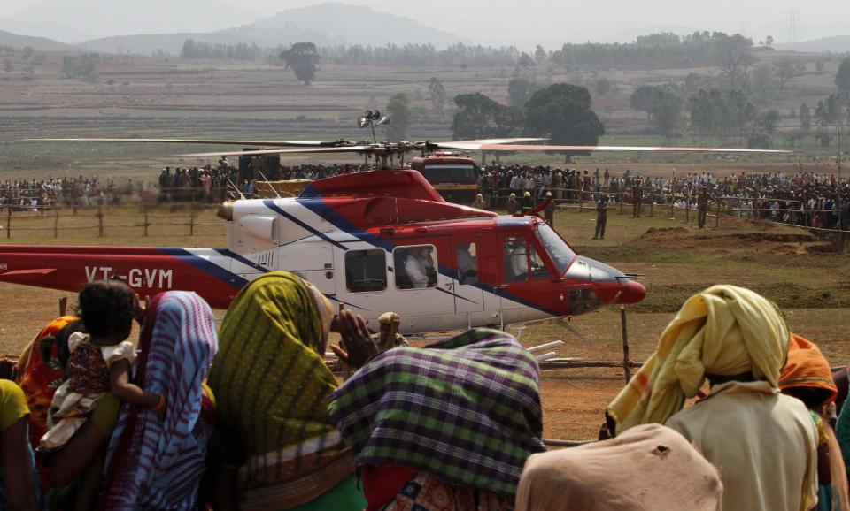 In this Monday, March 31, 2014 photo, India's ruling Congress party Vice President Rahul Gandhi waves from inside a helicopter as he leaves after addressing an election campaign rally at Semiliguda in Koraput district, Orissa, India. The 2014 elections would cost the government around $600 million. Separately, what candidates and political parties spend on their campaigns could run into billions of dollars. The Election Commission has put an official ceiling of 7 million rupees ($114,000) that each candidate can spend, but it's common knowledge that millions more are spent on hiring helicopters, vehicles, publicity, and sometimes a little liquor can go a long way in upping a candidate's chances, swinging the vote. (AP Photo/Biswaranjan Rout)