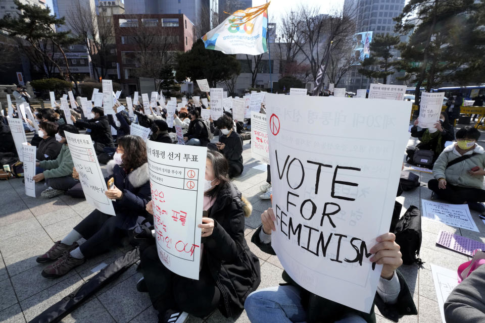 People stage a rally supporting feminism in Seoul, South Korea, Feb. 12, 2022. For years, the story of South Korean women has been defined by perseverance as they made gradual but steady progress in the workplace and fought against a deeply entrenched culture of misogyny and harassment. (AP Photo/Ahn Young-joon)