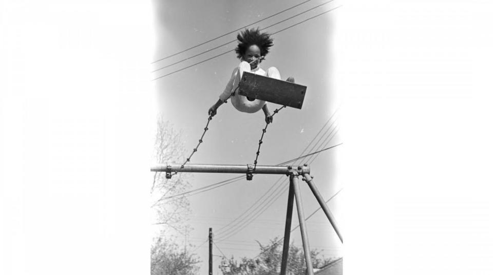 PHOTO: Sheyann Webb on a swing in George Washington Carver Park in Selma, Alabama, during a commemoration of the Selma to Montgomery March, Apr. 9, 1966. (Jim Peppler/Alabama Department of Archives and History)