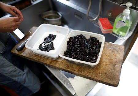 Yoko Ichihara cooks deep-fried whale nuggets inside the kitchen at her restaurant named P-man in Minamiboso