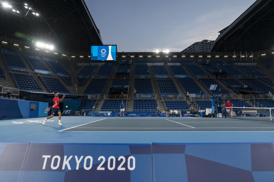 Novak Djokovic, of Serbia, left, practices at the Ariake Tennis Center ahead of the 2020 Summer Olympics, Wednesday, July 21, 2021, in Tokyo, Japan. (AP Photo/Alex Brandon)