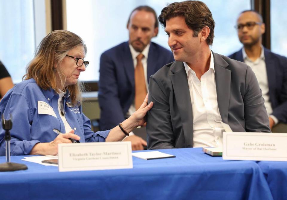 Virginia Gardens Council Member Elizabeth Taylor-Martinez, left, and Bal Harbour Mayor Gabe Groisman share a a moment during a press conference with local mayors about the affordability crisis on Wednesday, May 18, 2022, at the Stephen P. Clark Center in downtown Miami. They shared what they have done in their towns and discussed what they could do together.