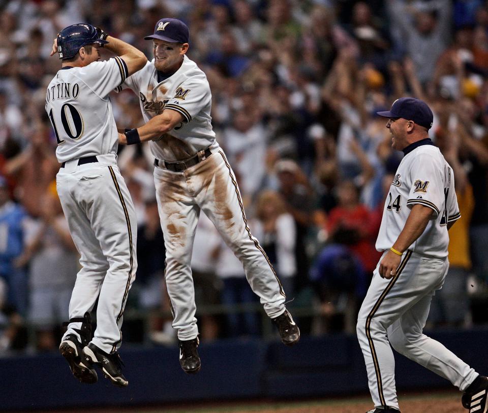 Milwaukee Brewers players Vinny Rottino, Geoff Kenkins and Kevin Mench celebrate after Rottino drove in the winning run in the 11th inning to beat the San Diego Padres 4-3 at Miller Park on Saturday, September 29, 2007.