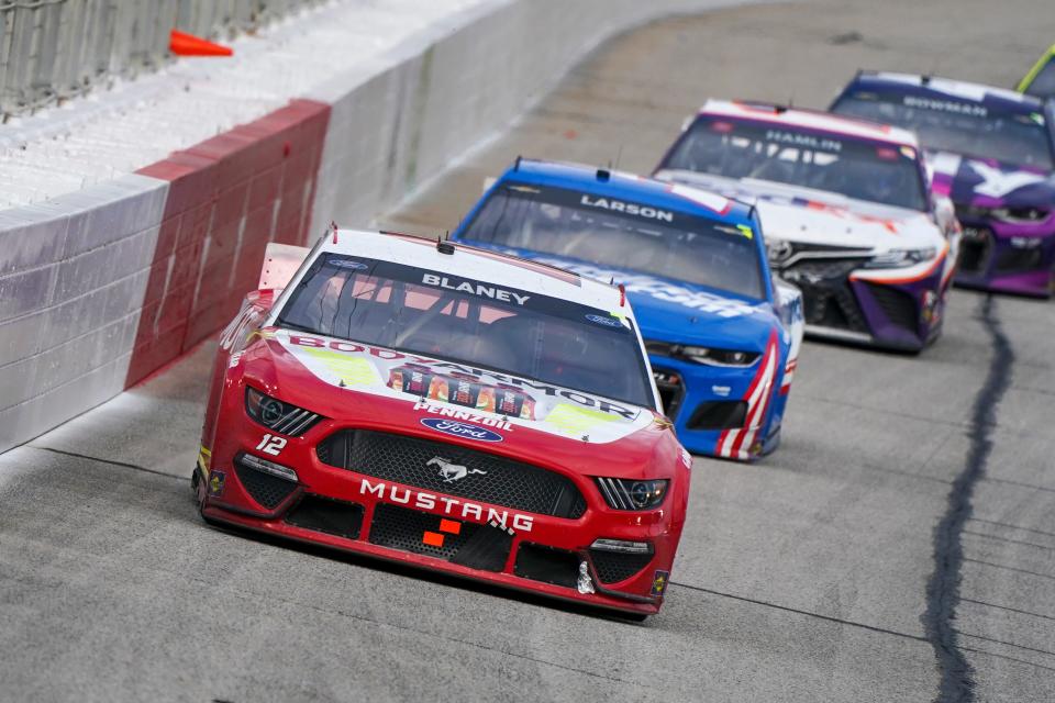 Ryan Blaney (12) leads driver Kyle Larson (5) during the closing laps of the spring race at Atlanta Motor Speedway on March 21, 2021.