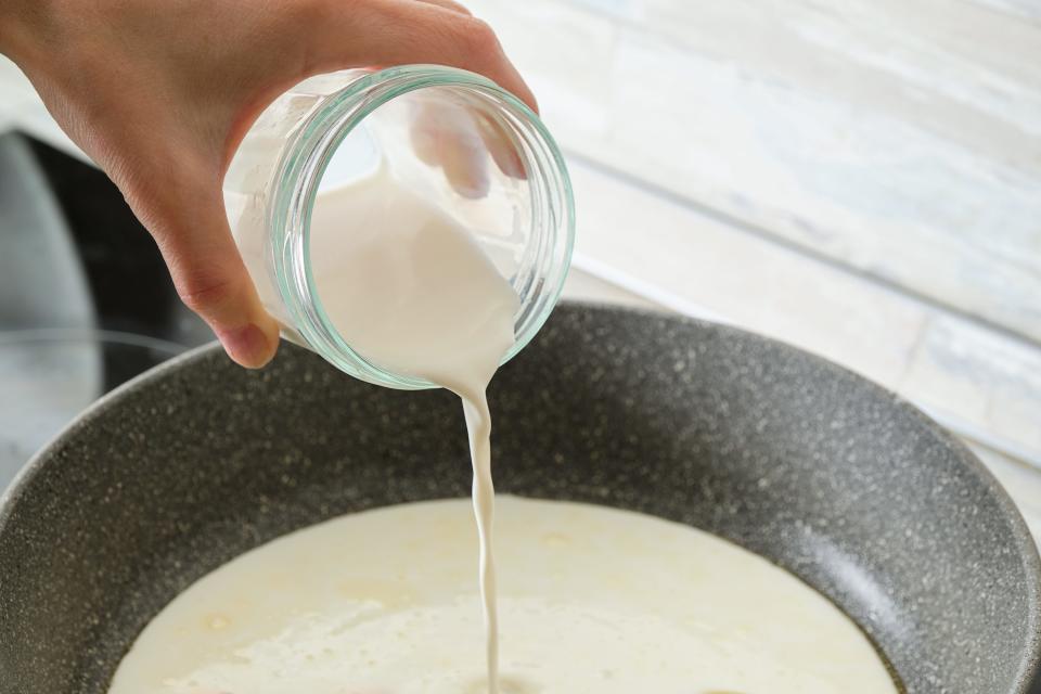 Cream being poured into pan