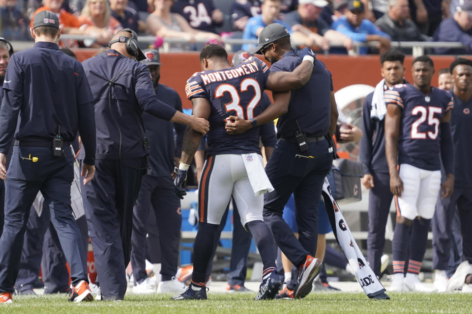 Chicago Bears running back David Montgomery is assisted off the field during the second half of an NFL football game against the Detroit Lions Sunday, Oct. 3, 2021, in Chicago. The Bears won 24-14. (AP Photo/David Banks)