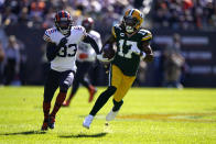 Green Bay Packers wide receiver Davante Adams (17) heads down field on a huge gain off a pass from quarterback Aaron Rodgers as Chicago Bears cornerback Jaylon Johnson pursues during the first half of an NFL football game against the Chicago Bears Sunday, Oct. 17, 2021, in Chicago. (AP Photo/Nam Y. Huh)