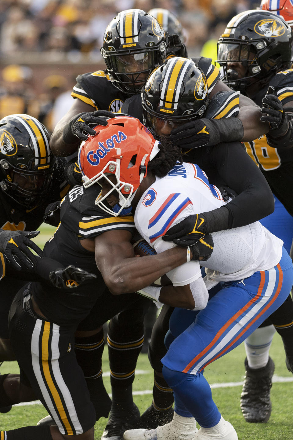 Florida quarterback Emory Jones is tackled by several Missouri defenders during the first quarter of an NCAA college football game Saturday, Nov. 20, 2021, in Columbia, Mo. (AP Photo/L.G. Patterson)