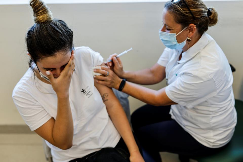 A teenager receives a dose of a Covid vaccine in Ashkelon, Israel (REUTERS)