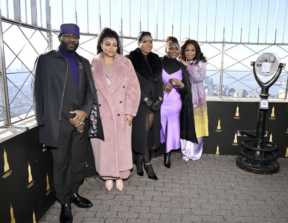 Blitz Bazawule, from left, Taraji P. Henson, Fantasia Barrino, Danielle Brooks and Oprah Winfrey from "The Color Purple" participate in the ceremonial lighting of the Empire State Building on Tuesday, Dec. 12, 2023, in New York. (Photo by Evan Agostini/Invision/AP)