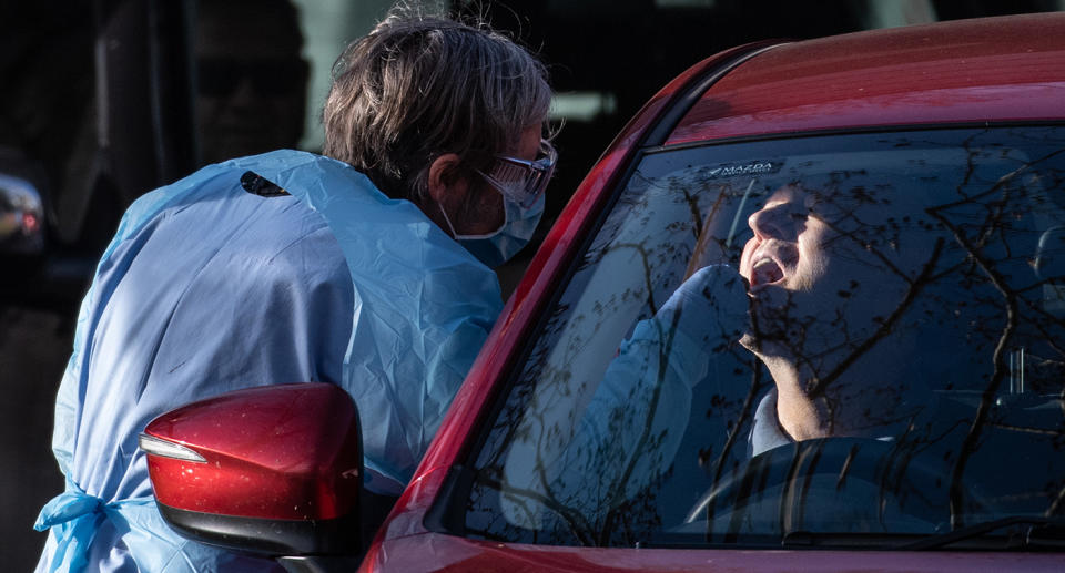 Healthcare workers conduct COVID-19 tests at a drive-through testing centre in Rozelle, Sydney, Friday, July 3, 2020. Health authorities are urging people in an inner-west Sydney suburb to be alert for COVID-19 symptoms after a local Woolworths worker tested positive for the virus. (AAP Image/James Gourley) NO ARCHIVING