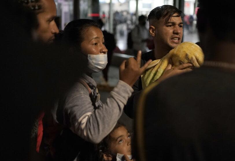 Venezuelan migrants discuss their plans as they wait for a bus to take them north at the Northern Bus Station in Mexico City, Thursday, Oct. 13, 2022. The U.S. announced on Oct. 12, that Venezuelans who walk or swim across the border will be immediately returned to Mexico without rights to seek asylum. (AP Photo/Eduardo Verdugo)