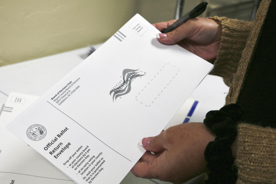 Wayne County Elections Director Anne Risku prepares absentee ballots at the Wayne County Board of Elections office on Thursday, Sept. 22, 2022, in Goldsboro, N.C. (AP Photo/Hannah Schoenbaum)