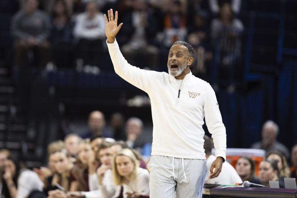 Virginia Tech head coach Kenny Brooks yells to his players during the first half of an NCAA college basketball game against Virginia, Sunday, March. 3, 2024, in Charlottesville, Va. (AP Photo/Mike Kropf)
