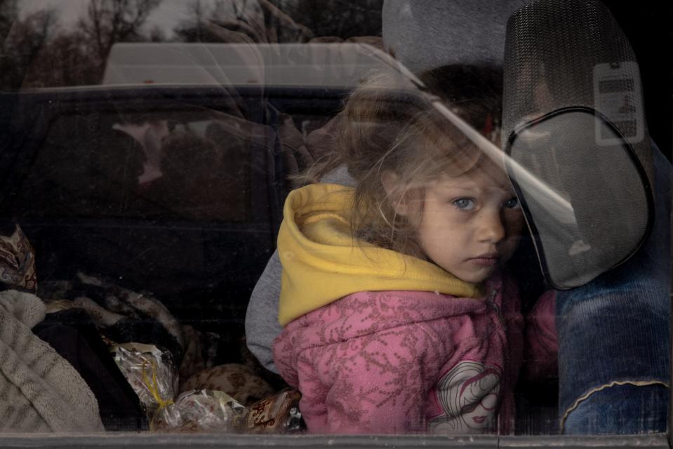 A girl looks out the window of her families car after arriving at an evacuation point for people fleeing Mariupol, Melitopol and the surrounding towns under Russian control on 23 April 2022 in Zaporizhzhia, Ukraine (Getty Images)