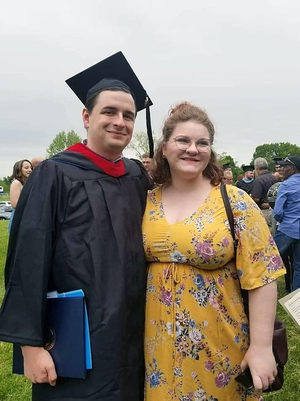 In this image provided by Sydnee Shipley, Jared Shipley poses for a photo with his wife, Sydnee, at his graduation from Ohio Valley University in Vienna, W.Va. in 2019. Shipley, who studied to become a preacher at the Christian university, struggled to find work after he was unable to access his transcript records, which the school said were deleted from its database after the system was hacked following the announcement of its closure in December 2021. (Sydnee Shipley via AP)