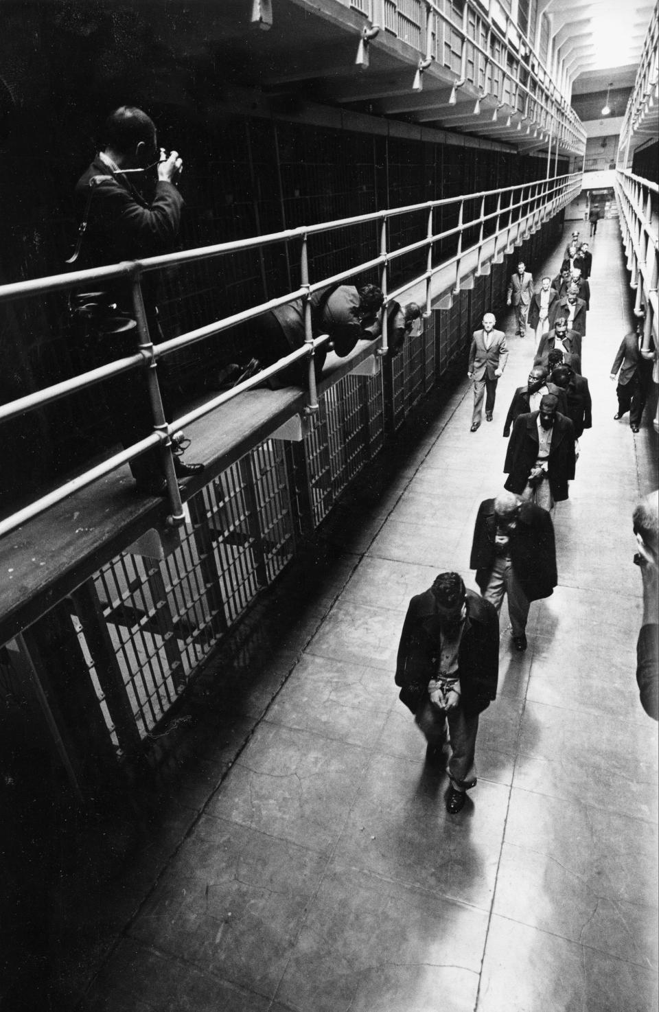 File - In this March 21, 1963 file photo the last prisoners depart from Alcatraz Island federal prison in San Francisco. The National Park Service on Thursday celebrated the 50th anniversary of Alcatraz Island's closure as a federal penitentiary with an exhibit of newly discovered photos of the prison's final hours.  The new display opened five decades after the last shacked prisoners were taken off the infamous prison in San Francisco Bay that once held the likes of gangsters Al Capone and Mickey Cohen. (AP Photo/File)