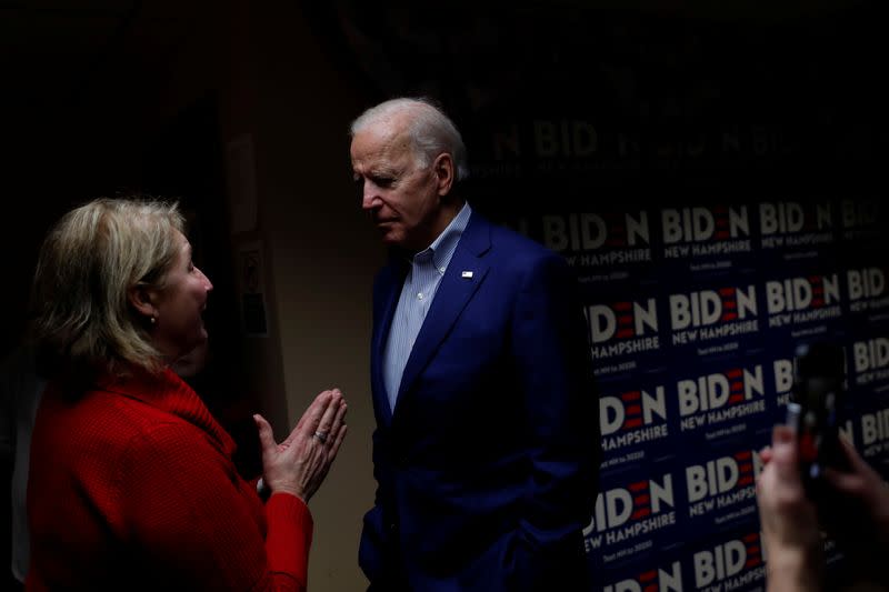 Democratic 2020 U.S. presidential candidate and former Vice President Joe Biden speaks with a volunteer at a campaign office in Salem, New Hampshire