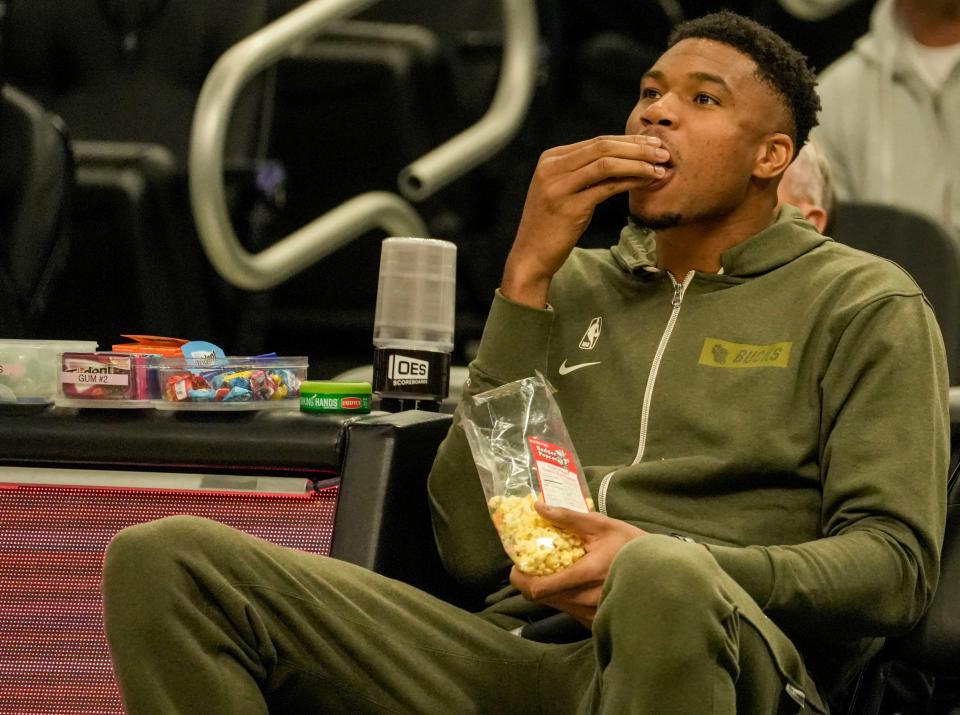 Milwaukee Bucks forward Giannis Antetokounmpo snacks on popcorn during the second half of the preseason game against Memphis Grizzlies on Saturday at Fiserv Forum in Milwaukee. The Bucks lost to the Grizzlies 107-102.