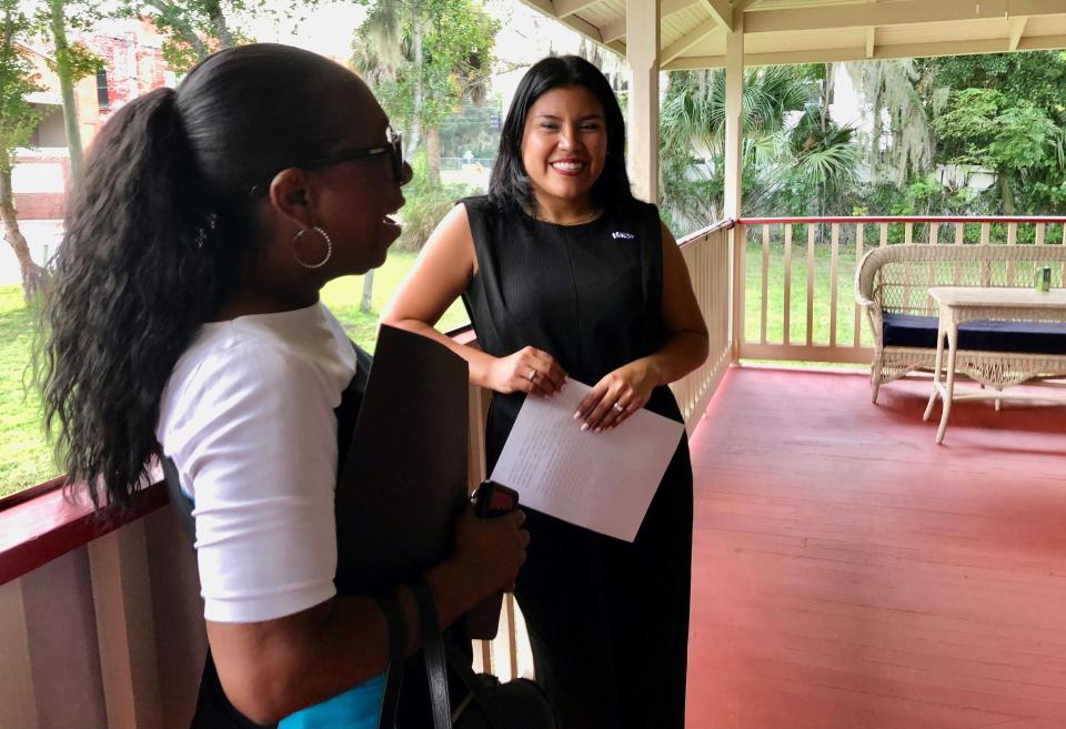 Karla Hernandez-Mats, Democratic candidate for lieutenant governor, chats with Cynthia Slater, president of the Daytona Beach branch of the NAACP, on the veranda of the Volusia County Democratic headquarters in DeLand. Hernandez-Mats, who's running in support of Charlie Crist against Gov. Ron DeSantis, stopped in Volusia County on Friday evening.