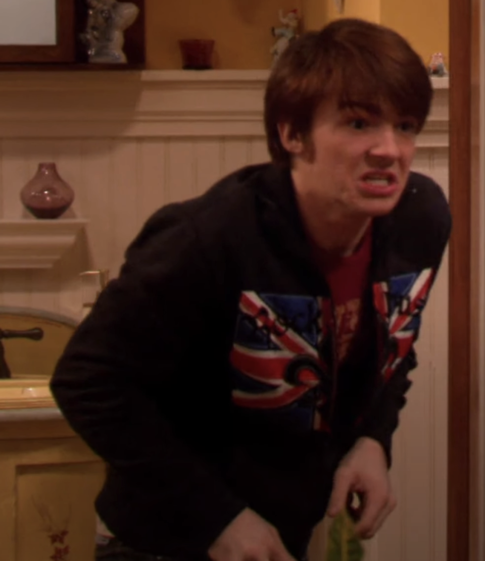 Drake Bell from "Drake & Josh"  looking upset in a kitchen scene