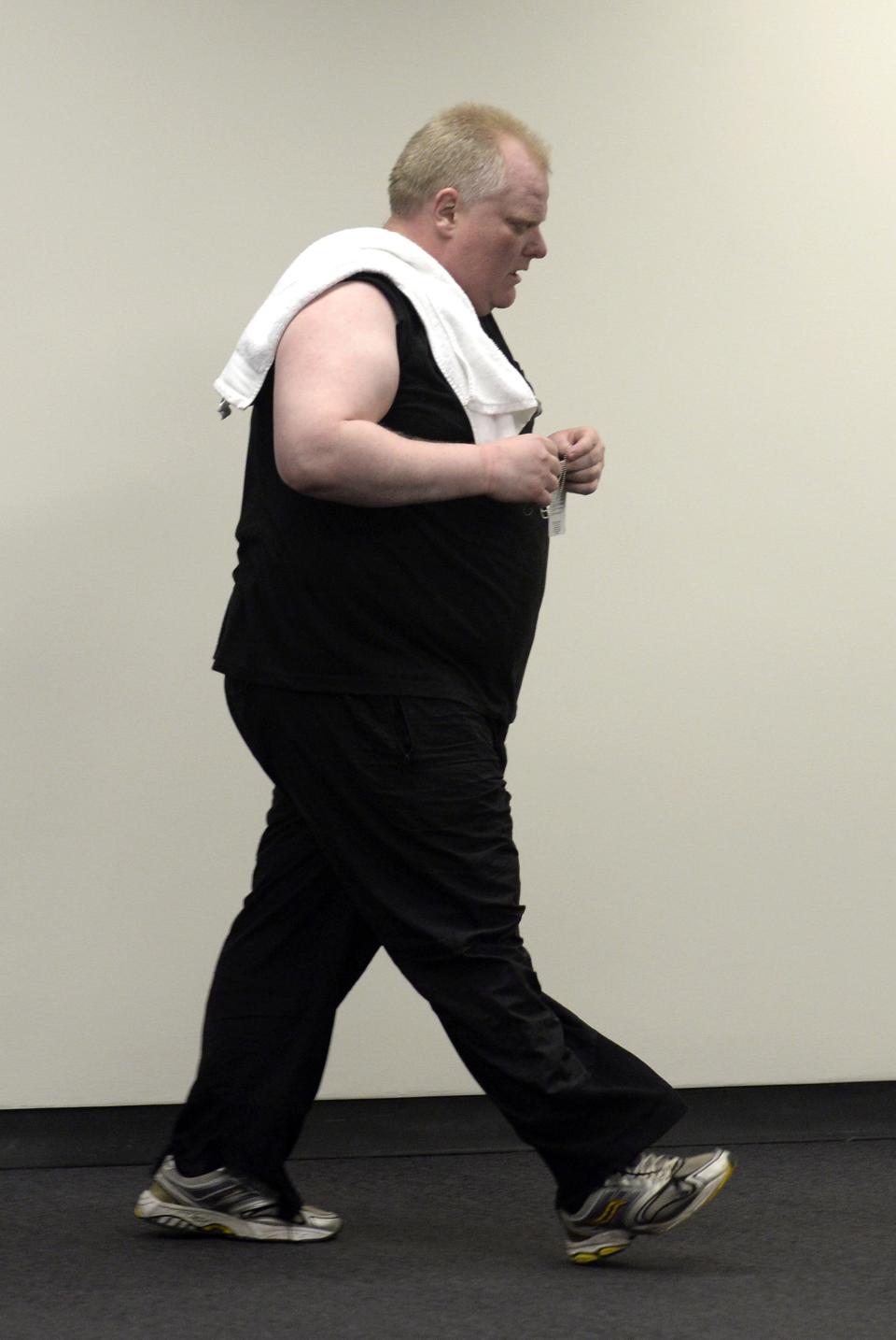 Toronto Mayor Rob Ford returns to his office in gym attire during a break in an executive committee meeting at City Hall in Toronto