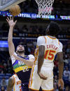 New Orleans Pelicans forward Larry Nance Jr. (22) shoots in front of Atlanta Hawks center Clint Capela (15) during the first half of an NBA basketball game in New Orleans, Tuesday, Feb. 7, 2023. (AP Photo/Matthew Hinton)