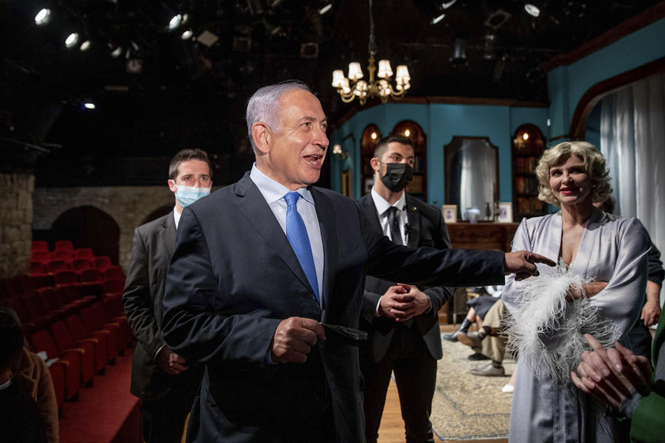 Israeli Prime Minister Benjamin Netanyahu meets Israeli actress Carmit Mesilati Kaplan, right, during a visit to the Khan theater ahead of the re-opening of the culture sector, in Jerusalem on Tuesday, Feb. 23, 2021. (Ohad Zwigenberg/Pool Photo via AP)