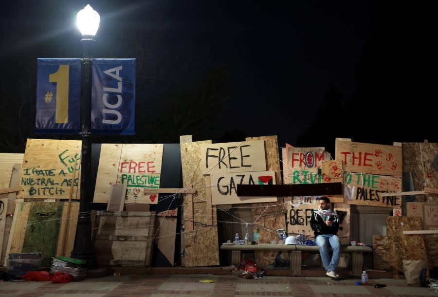 LOS ANGELES, CALIFORNIA – May 2: A pro-Palestinian protester sits on a bench after an oder to disperse was given by law enforcement at UCLA early Thursday morning. (Wally Skalij/Los Angeles Times via Getty Images)