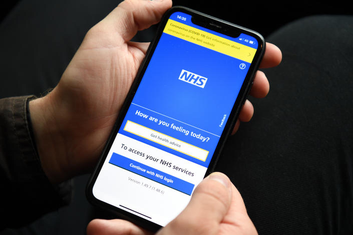 A person holding a mobile phone displaying the NHS app. The NHS app will be used by holidaymakers in England to prove their coronavirus status to destination countries, Transport Secretary Grant Shapps has announced. Picture date: Wednesday April 28, 2021. (Photo by Kirsty O&#39;Connor/PA Images via Getty Images)
