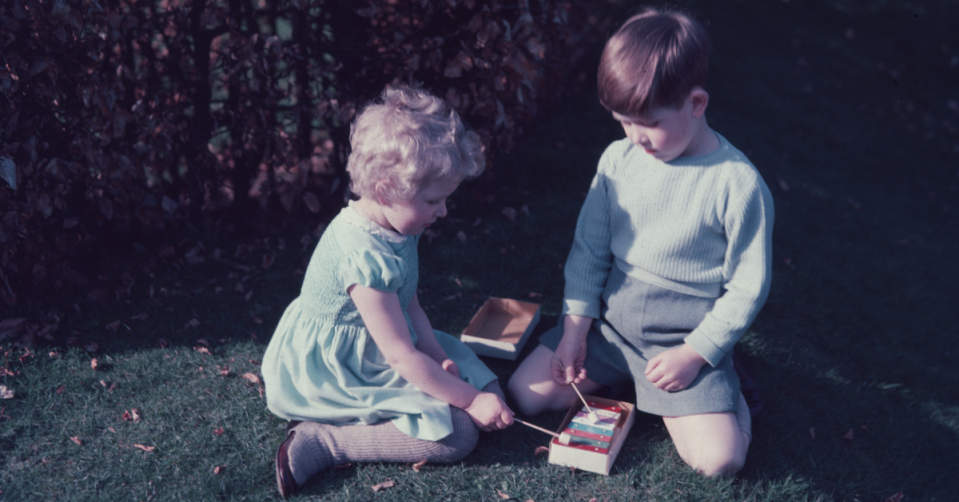 Princess Anne left and King Charles right as children play a glockespiel