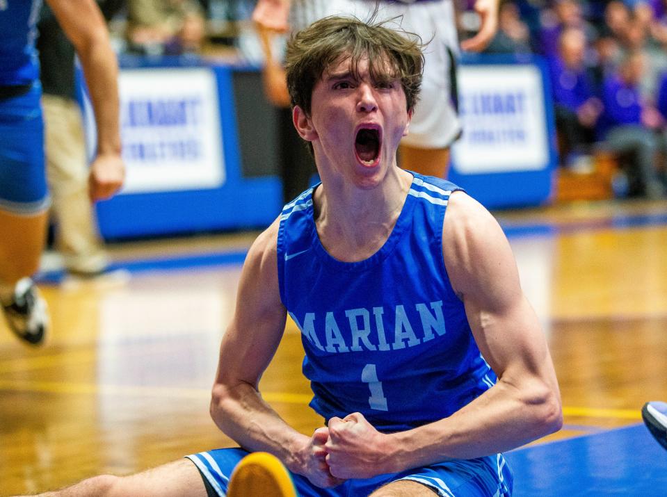 Marian's Deaglan Sullivan (1) celebrates scoring after being fouled during the Marian vs. Leo semistate championship boys basketball game Saturday, March 19, 2022 at Northside Gym in Elkhart. 