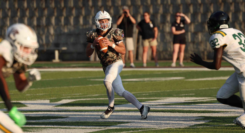 Roger Bacon quarterback Jimmy Mumper threw three touchdowns Friday night in the Spartans' 30-7 win over Norwood.