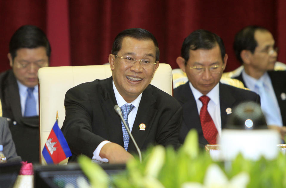 Cambodian Prime Minister Hun Sen, center, smiles during an opening a plenary session at the 20th ASEAN Summit at the Peace Palace, in Phnom Penh Cambodia, Tuesday, April 3, 2012. (AP Photo/Heng Sinith)