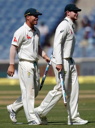 Cricket - India v Australia - First Test cricket match - Maharashtra Cricket Association Stadium, Pune, India - 25/02/17. Australia's captain Steve Smith (R) and his team mate David Warner walk off the ground after winning the match. REUTERS/Danish Siddiqui