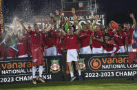 Wrexham players celebrate their promotion to the EFL following the National League soccer match between Wrexham and Boreham Wood at The Racecourse Ground, in Wrexham, Wales, Saturday April 22, 2023. (Martin Rickett/PA via AP)