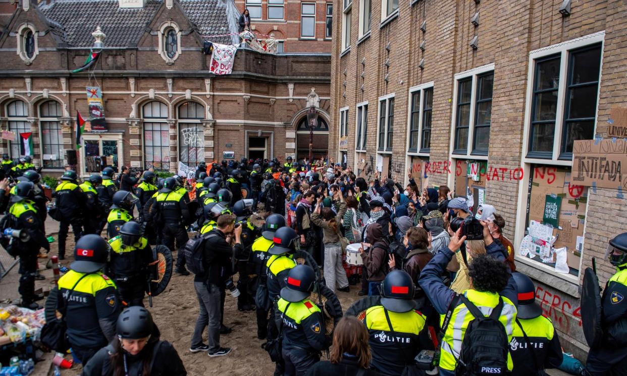 <span>Police ended the student occupation at the University of Amsterdam by breaking through barricades.</span><span>Photograph: Michael Currie/Sopa Images/Rex/Shutterstock</span>