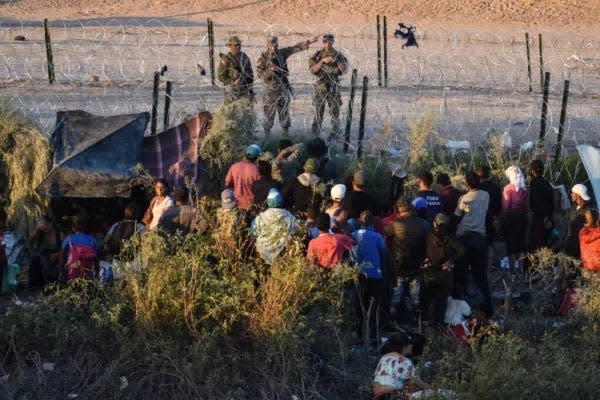 Large groups of migrants got past rows of law enforcement agents and vehicles in Juarez and crossed the Rio Grande on Tuesday. Many camped out along the concertina wire fencing put up by the Texas National Guard.