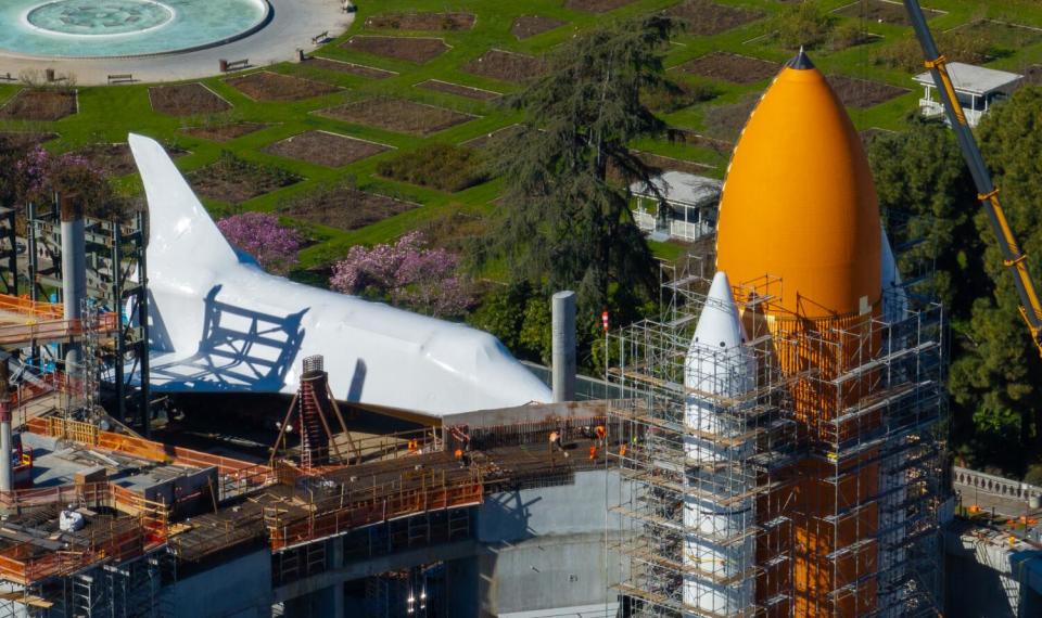 The space shuttle Endeavor is near its external fuel tanks.